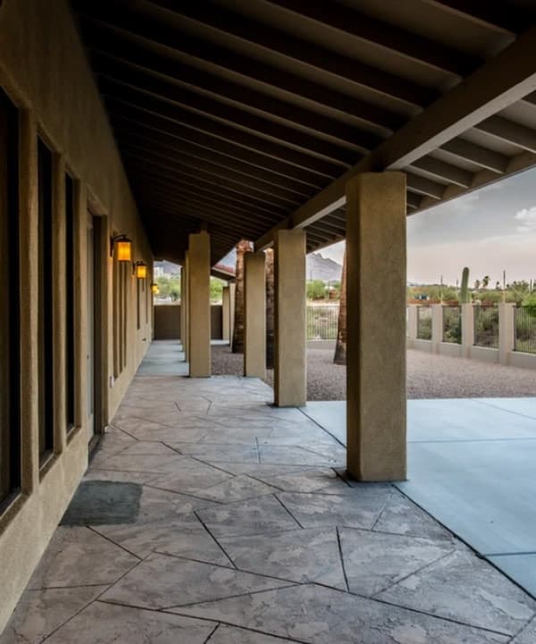 The covered walkway of a Tucson residential care home, with desert and mountains beyond